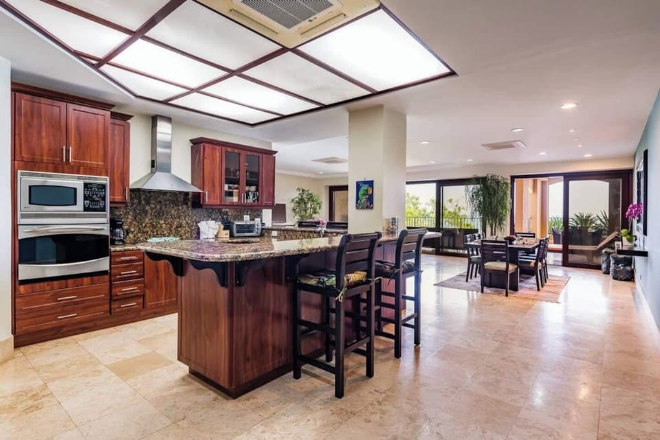 Bright and spacious open-plan layout featuring a stylish kitchen with ample counter space, a welcoming lounge area, and a sunlit dining nook. All flow seamlessly to a private ocean-view balcony in this Tamarindo retreat near Langosta Beach.