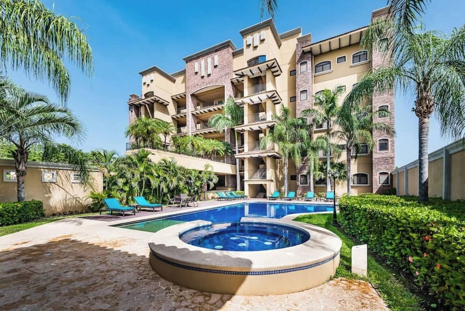 Modern pool area set against the sleek Crystal Sands building, blending tropical design with architectural elegance. Just steps from Langosta Beach in Tamarindo, this upscale condo offers ocean views and tranquil outdoor living.