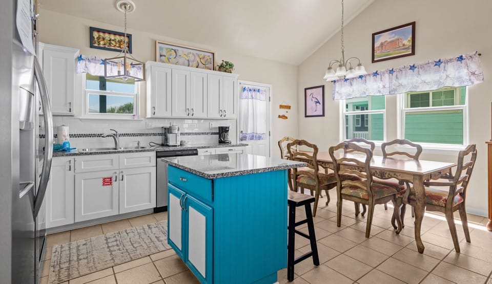 Kitchen alternate angle — turquoise beadboard island, dining table & starfish valances