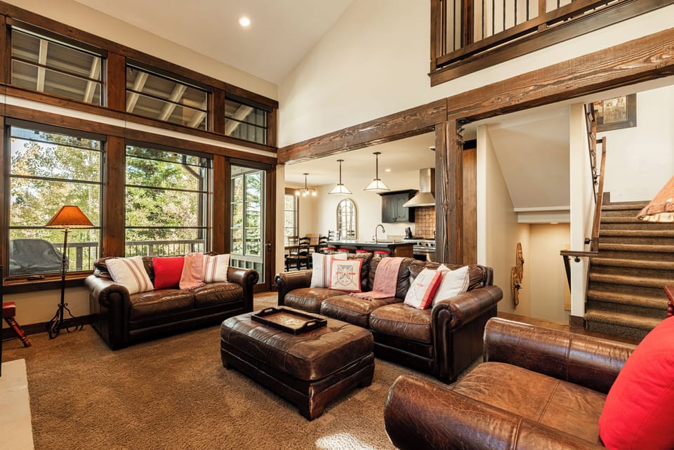 Vaulted great room with cozy red accents and large windows