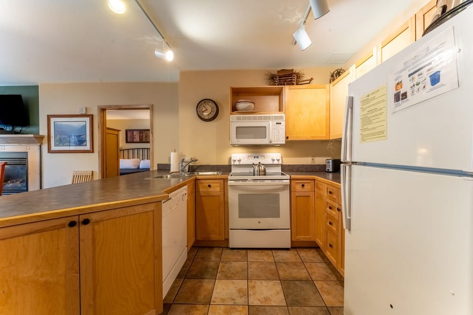 Your fully equipped kitchen features warm wood cabinets, stainless steel appliances, and all the essentials for home-style cooking during your stay.
