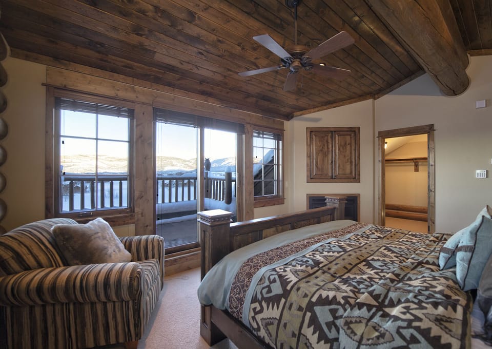 Wake up to breathtaking mountain vistas from your cozy bedroom, where rustic wood beams and warm textures create the perfect alpine retreat for your mountain getaway.