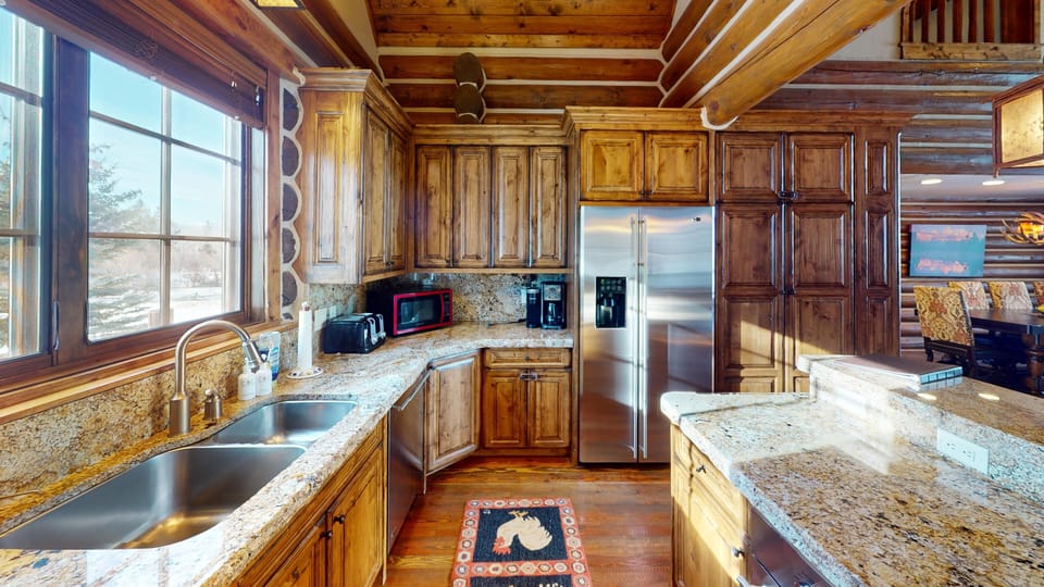 Your rustic kitchen features granite counters, stainless steel appliances, and warm wood cabinetry for memorable meal preparation.
