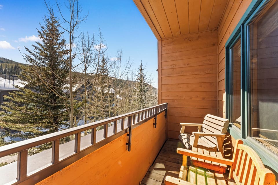 Bask in alpine sunshine on your private balcony, where wooden chairs invite you to sip morning coffee while gazing at snow-dusted peaks and evergreen forests.