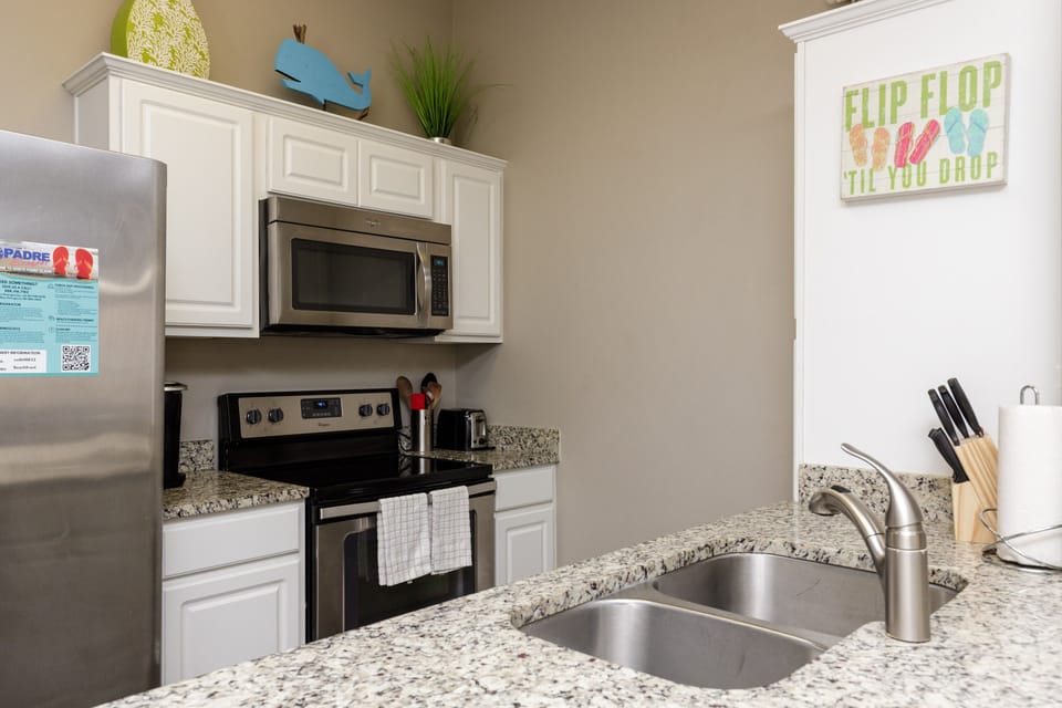 Your fully equipped kitchen features granite counters, stainless appliances, and everything needed to cook your favorite meals.