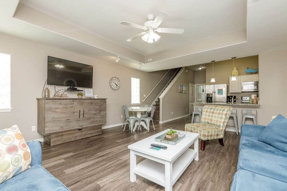 Unwind in your spacious open-plan living area with comfortable seating and modern amenities for the perfect home-away-from-home experience.