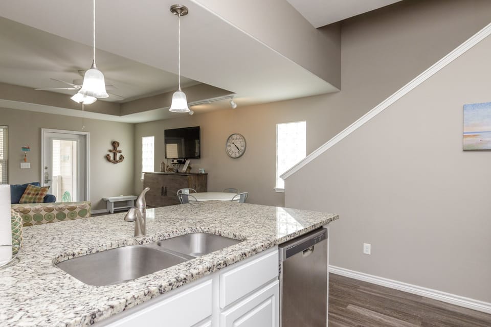Your open kitchen island flows into the living area, perfect for morning coffee or entertaining guests in this bright, modern space.