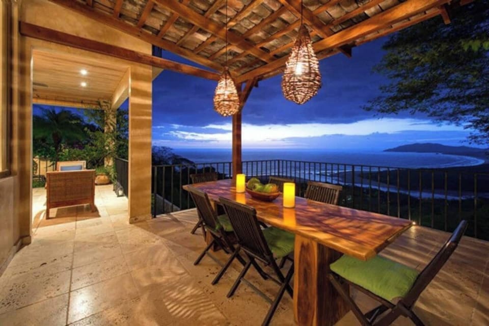 Elegant dining area with luxury design and breathtaking views of Tamarindo — a perfect space to share meals in your private vacation villa.