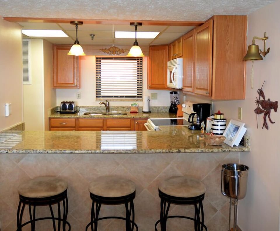 Another view of the breakfast bar and kitchen.