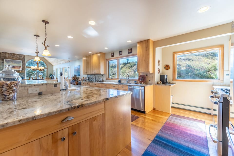 Your gourmet kitchen features granite countertops, stainless appliances, and stunning mountain views while you prepare memorable meals together.