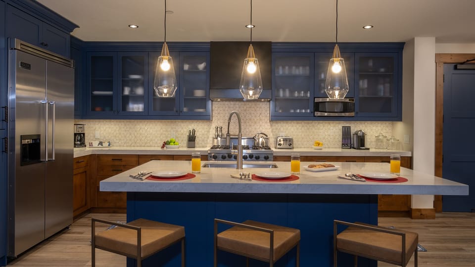 Kitchen, Main Level - Blue cabinetry with large island and pendant lighting