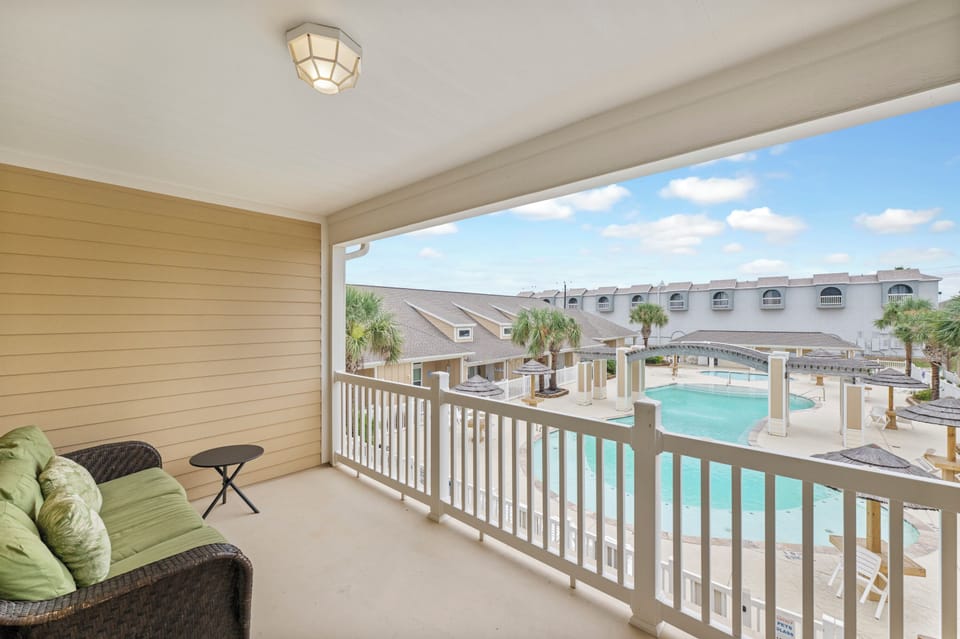 Your private balcony overlooking the sparkling pool creates the perfect spot to sip morning coffee or unwind with evening cocktails.