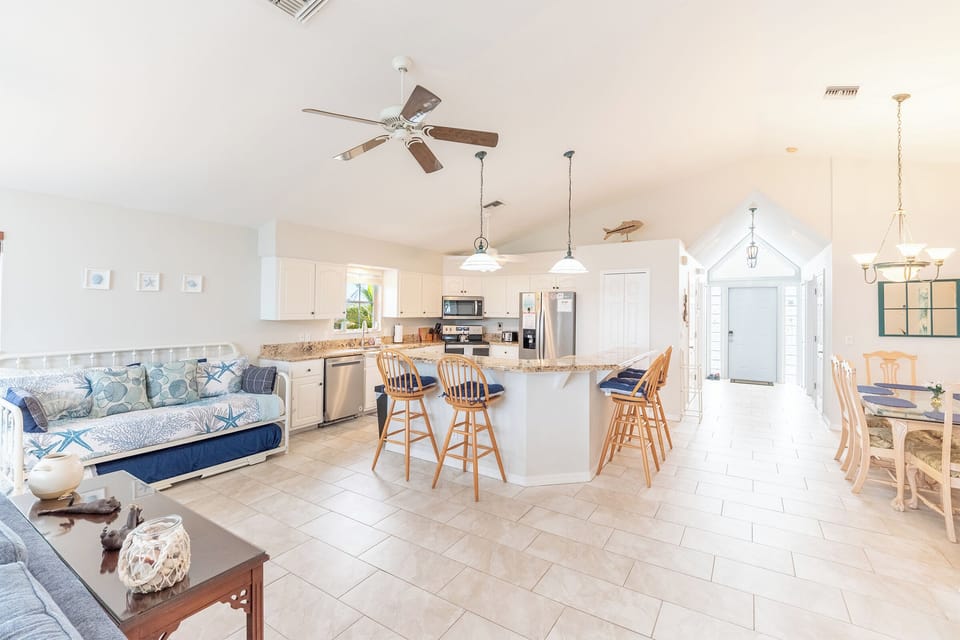 The open concept living and dining areas create a lovely flow of sea breezes and sunlight.