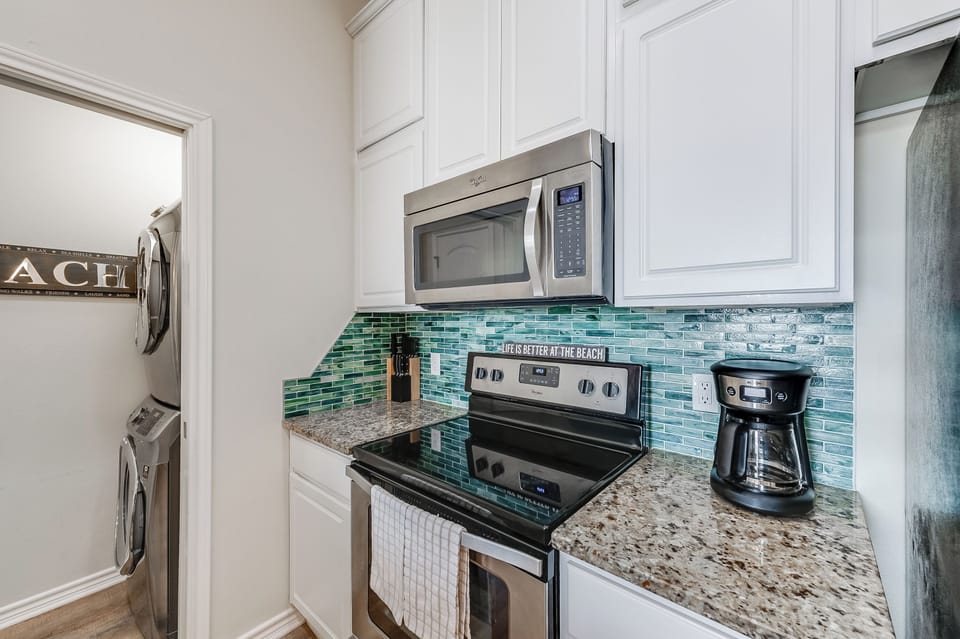 Your fully equipped kitchen features granite counters, ocean-inspired backsplash, and everything you need to create memorable meals during your stay.