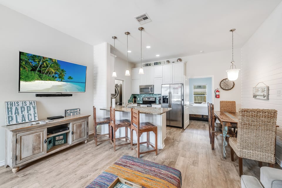 Unwind in your stylish open-concept space where coastal vibes meet modern comfort, featuring a gourmet kitchen perfect for creating vacation memories.