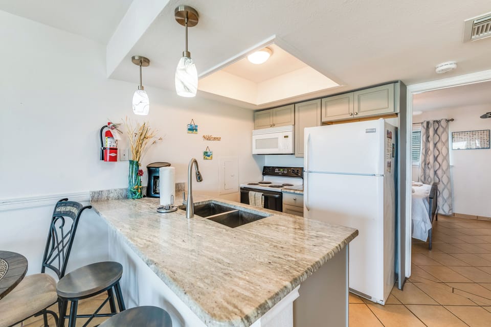 Your modern kitchen features granite counters, full appliances, and elegant pendant lighting—perfect for preparing meals during your stay.