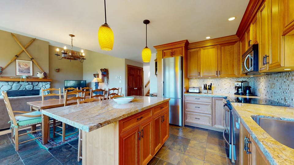 The modern kitchen is a chef's dream with ample counter space and warm design.