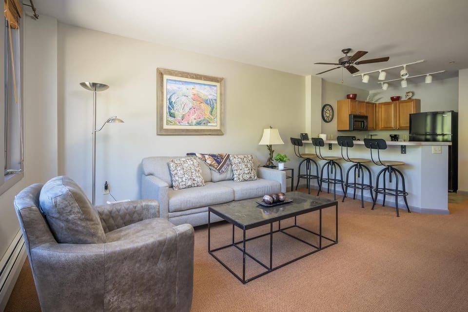 Seating for four at the breakfast bar which opens into the living room