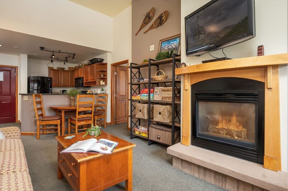 Large flat screen TV and gas fireplace in the family room