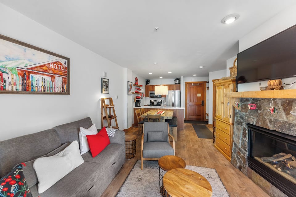 Cozy up in your mountain retreat with a warm fireplace, modern kitchen, and stylish furnishings creating the perfect alpine getaway.