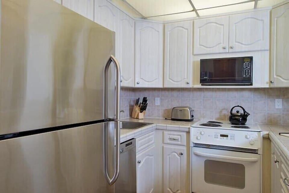 Bright, fully equipped kitchen featuring full-size appliances, generous cabinet storage, and everything you need to prepare meals during your Maui stay.