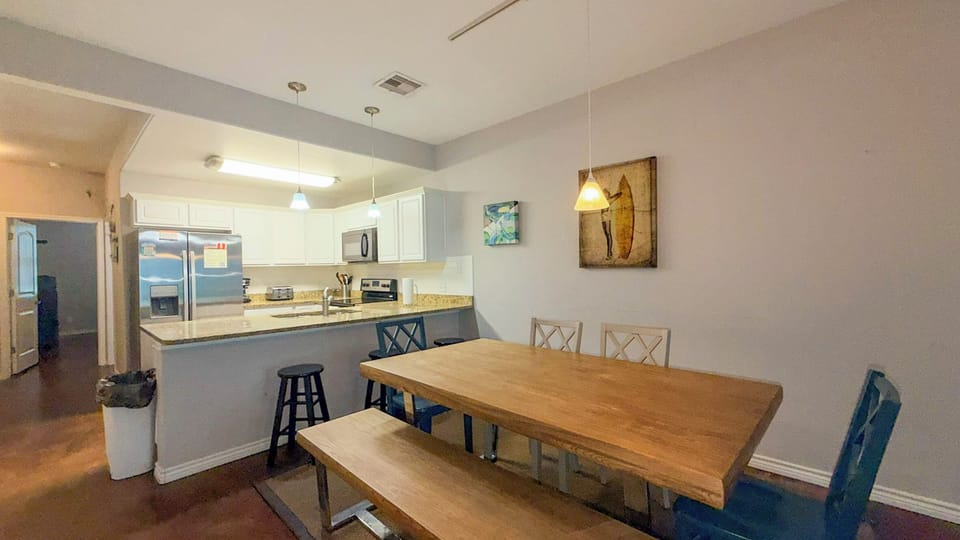 Gather around your spacious dining table where memorable meals and conversations unfold, perfectly connected to your fully-equipped kitchen.