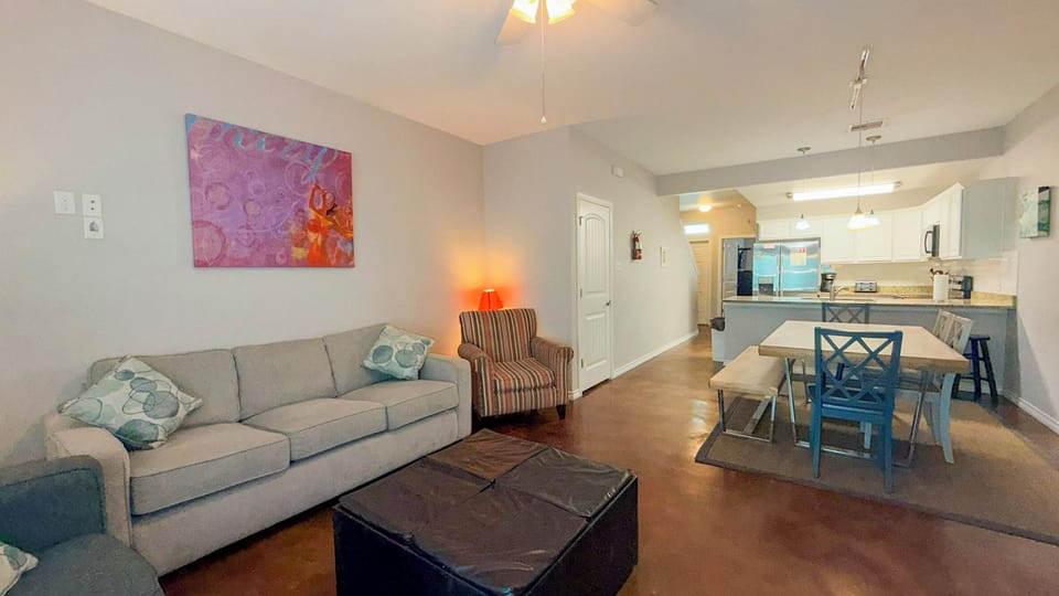 Settle into your bright, modern living space where comfort meets style—spacious sofa, stylish dining area, and open kitchen await your arrival.