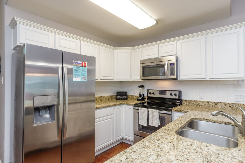 Your fully equipped kitchen awaits with granite countertops, stainless steel appliances, and all the modern conveniences for cooking memorable meals.