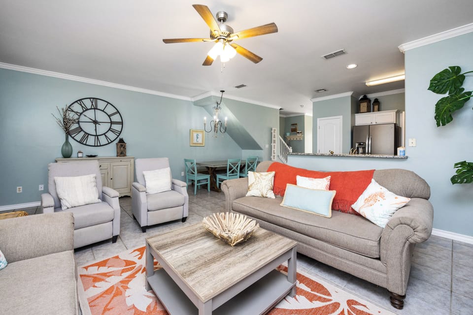 Unwind in your spacious living room featuring comfortable seating, coastal-inspired decor, and an open layout perfect for gathering with loved ones.