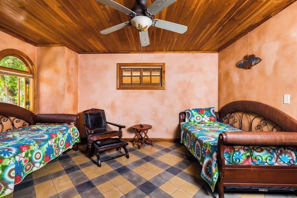 Bright and spacious second guest bedroom with modern Costa Rican design, ideal for families. Perfect for a Tamarindo vacation rental in Langosta, offering comfort, style, and a relaxing space for everyone.