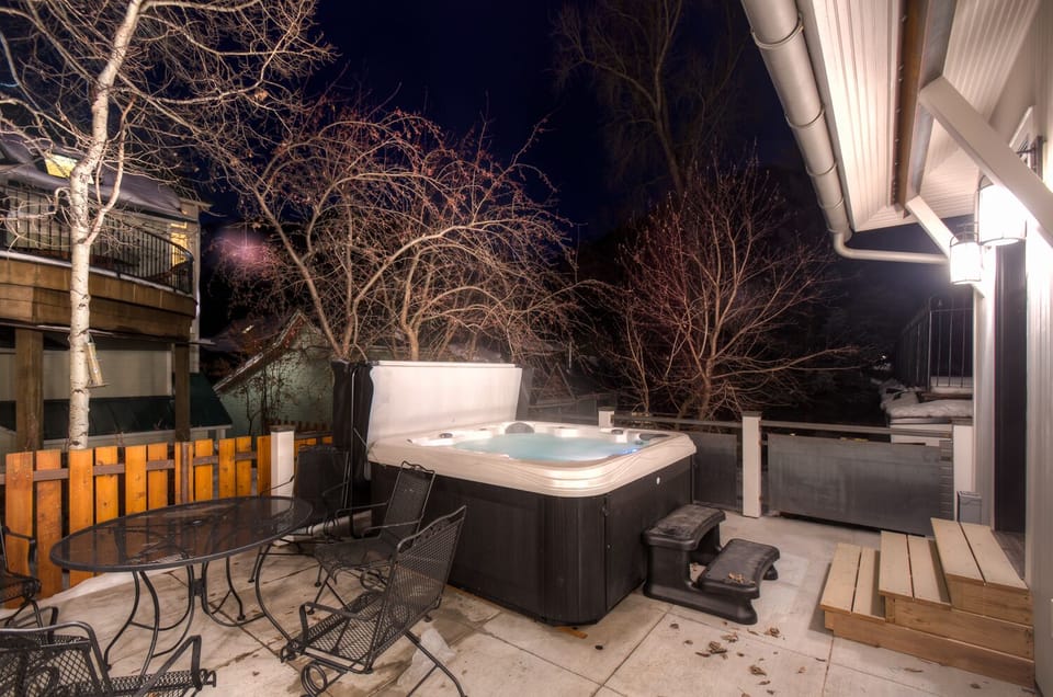 Back Patio with Hot Tub and Outdoor Seating for 6 at Miles High