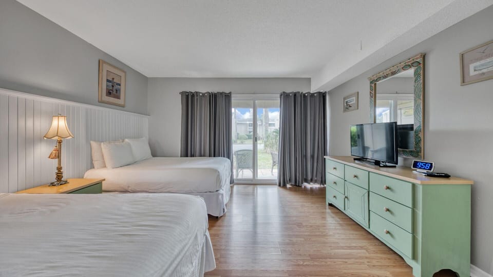 Bedroom With Two Full Beds, TV and Patio Access