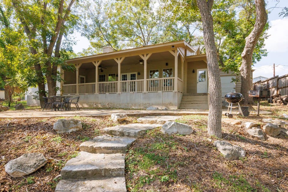 Back patio shaded by pecan and cypress trees