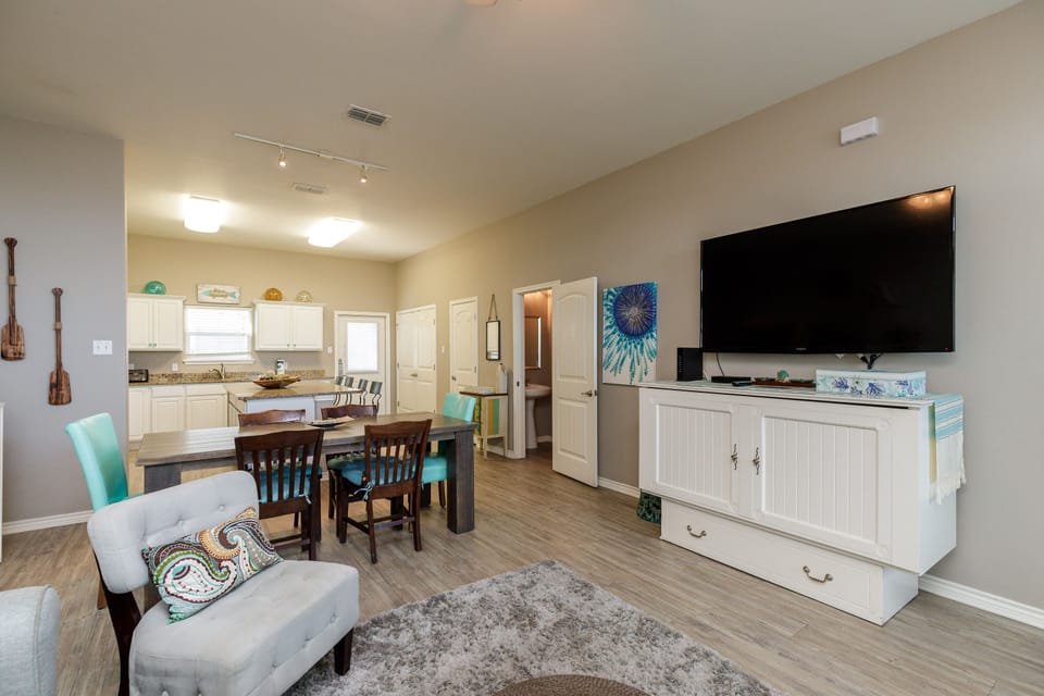 Step into your bright, open-concept haven where coastal charm meets modern comfort, perfect for relaxing evenings and memorable meals together.