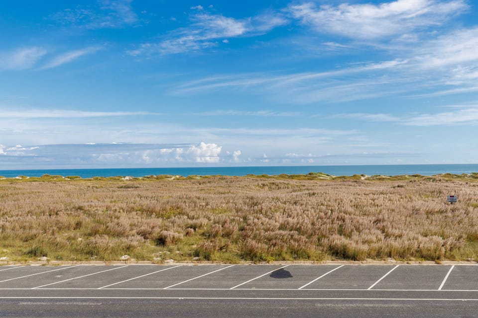 Convenient roadside parking provides easy access to coastal dunes and ocean views just steps from the property.