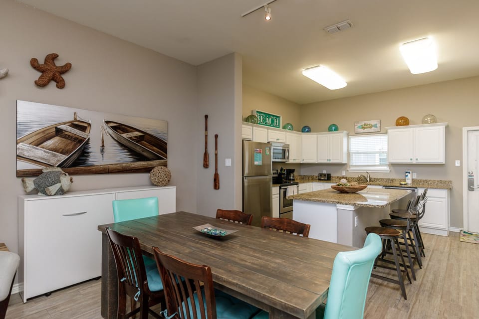 Gather around your spacious dining table while coastal art and nautical touches create the perfect beach house atmosphere.