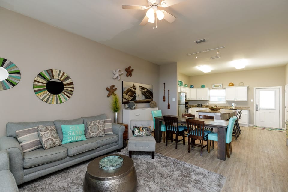 Step into your bright, open living space where coastal touches and modern comfort blend perfectly for relaxing evenings together.