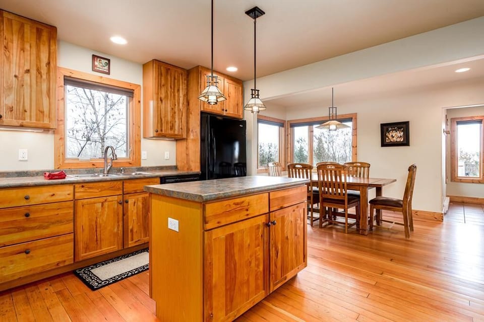 Open concept kitchen and dining area. Small kitchen island for additional cooking space.