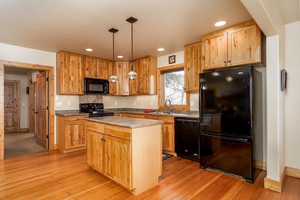 Full kitchen including a drip coffee maker.