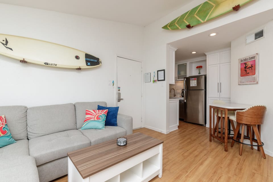 Relax in your bright, surf-inspired space where colorful paddleboards adorn the ceiling and coastal vibes meet modern comfort throughout.