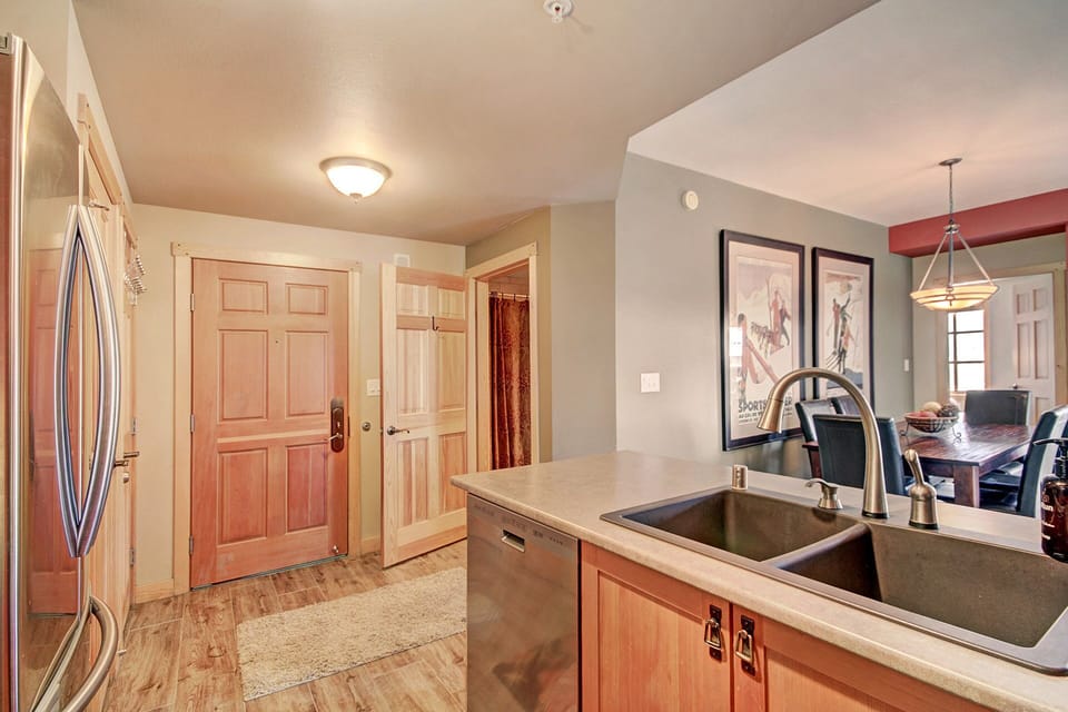 Kitchen area looking towards entrance and main bathroom.