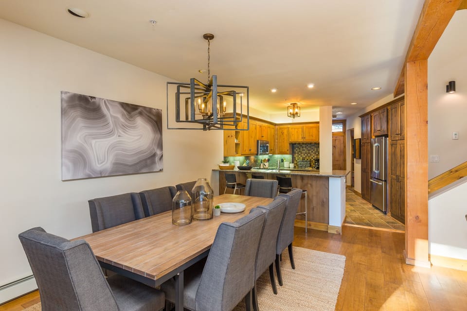 Gather around your beautiful dining table while the chef prepares meals in your fully equipped kitchen with warm wood finishes and modern touches.