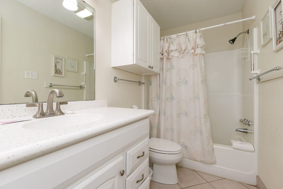 Your spacious bathroom features granite counters, ample storage, and a relaxing tub-shower combo for refreshing after busy days exploring.