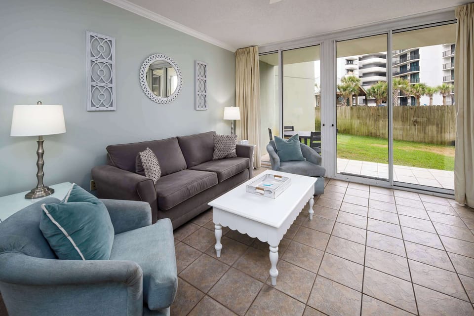 Living room with floor-to-ceiling sliders to the back patio