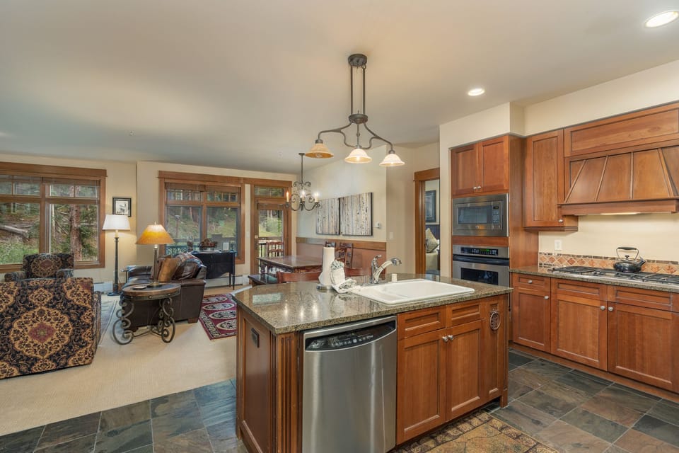 Your gourmet kitchen features granite countertops, premium appliances, and flows seamlessly into the cozy living area for memorable meals.