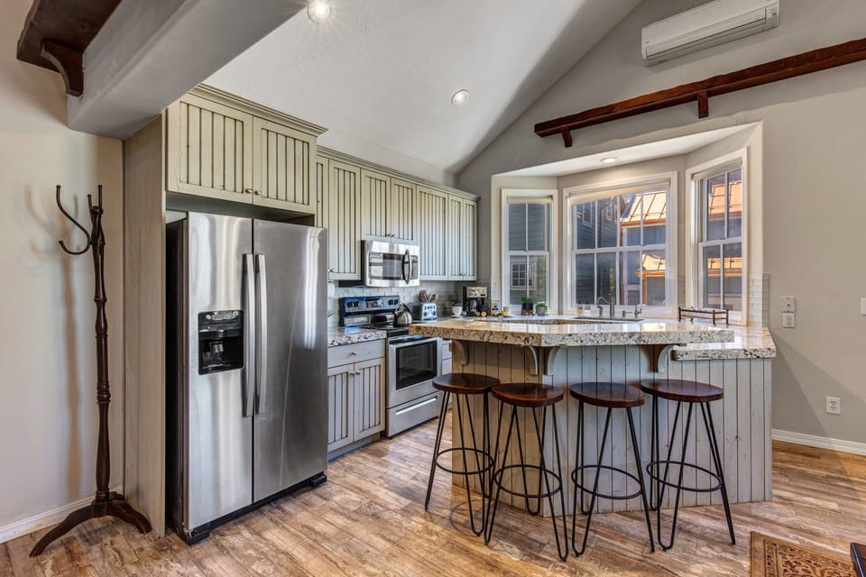 Stainless steel appliances and bar seating for four