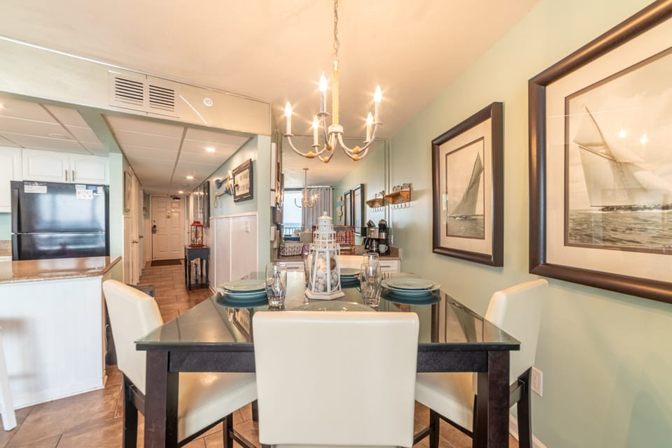 The dining room table comfortably seats 4 with additional seating at the bar