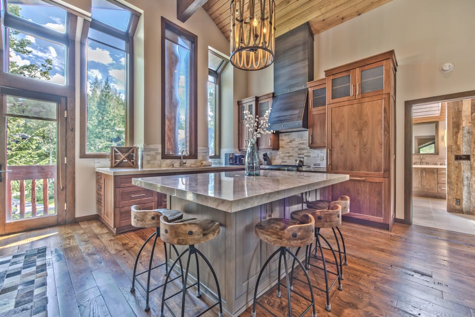 Fully Equipped Gourmet Kitchen with High-end Finishes, Thermador Refrigerator and 4-Burner Gas Stove, Stainless Steel Appliances, Bar Seating for 5, Front Deck Access and Entry to Upper Level Grand Master Bedroom and Bath