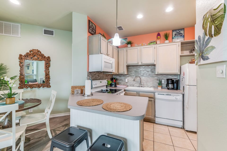 Your stylish kitchen features modern appliances, tropical touches, and a breakfast bar perfect for morning coffee conversations.