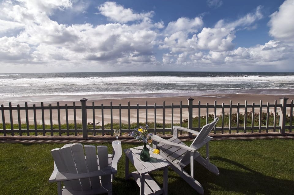 Private double lot on the oceanfront with rare grassed yard - Large grassy yard over the oceanfront.  Great for a game of croquet, whale watching or sunsets over the ocean.  Plenty of wooden adirondacks for everyone to enjoy a BBQ.   Stainless BBQ supplied.